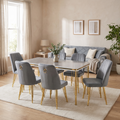 Paris dining set in a warm living-dining room, six grey velvet chairs, Berlin grey and silver sofa behind
