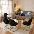 Prague dining set in a warm living-dining room, six black velvet chairs, Geneva grey and gold sofa behind