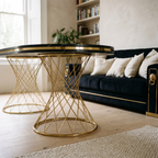 Milan table base detail — twin gold wire pedestals under the black marble-effect top