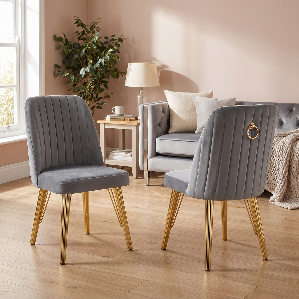 Paris dining chairs — grey velvet with vertical fluted backs and a gold ring pull on the outer back