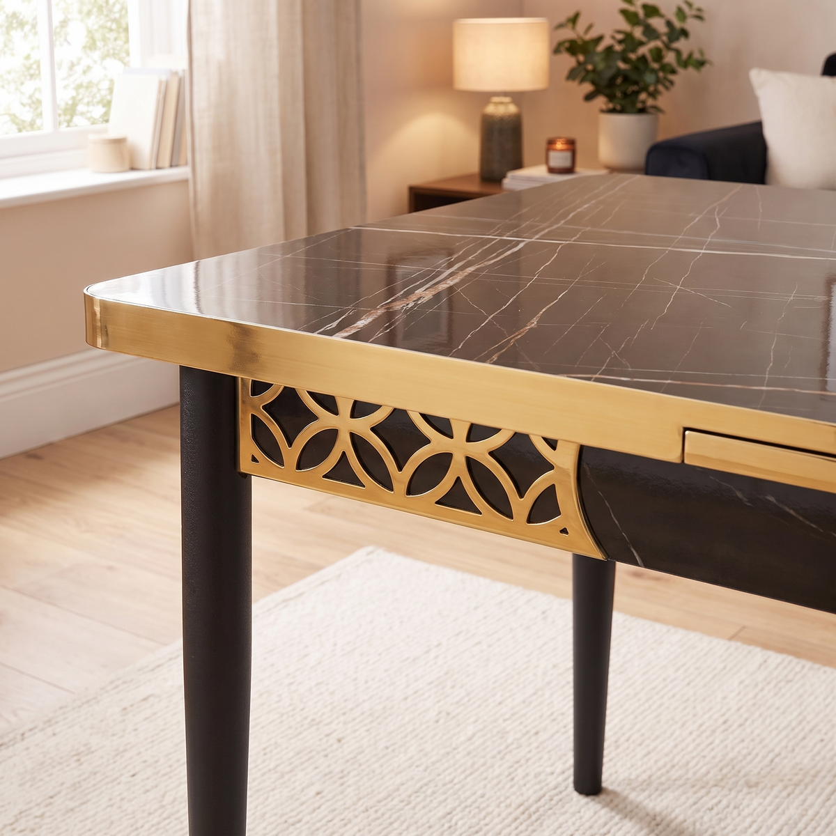 Istanbul table detail — the gold lattice of interlocking circles cut through the apron beneath the black marble-effect top